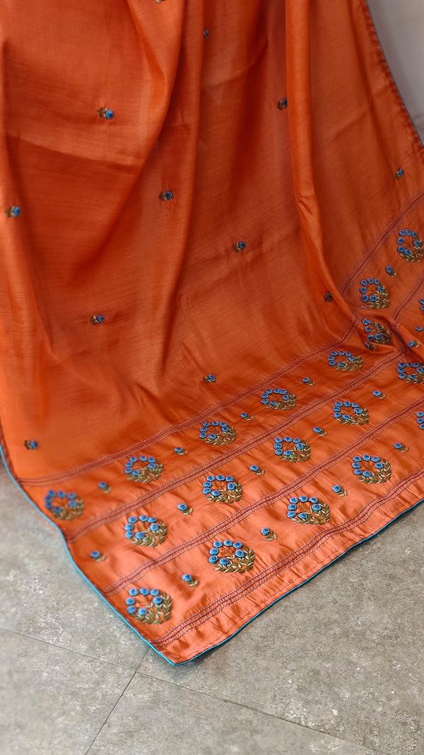 Orange muslin silk saree with hand embroidery