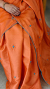 Orange muslin silk saree with hand embroidery
