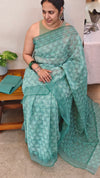 Teal green block printed organza saree