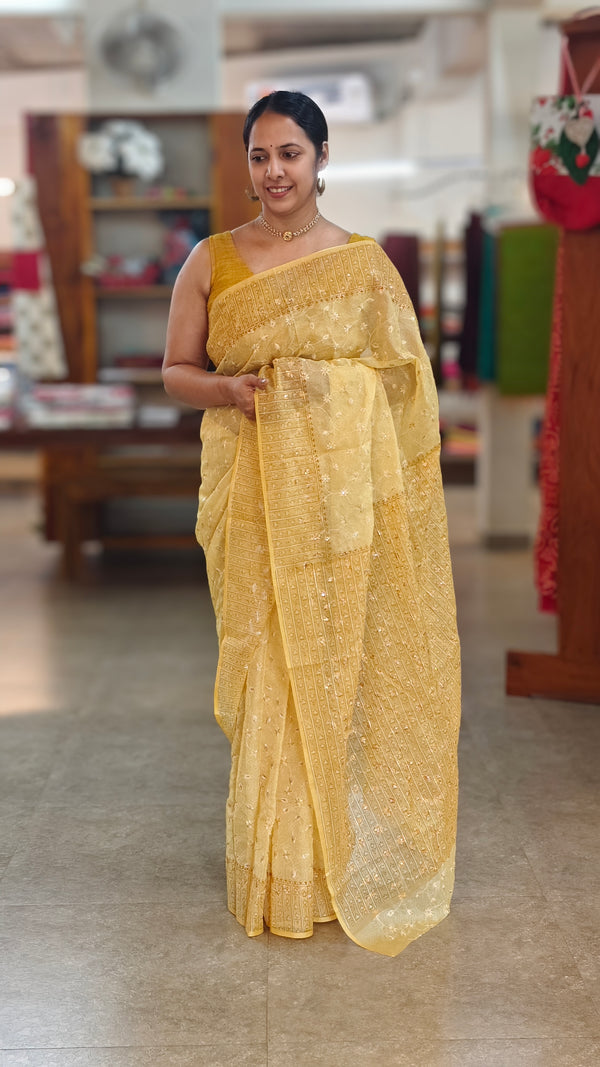 Yellow embroidered and block printed organza saree