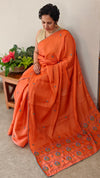 Orange muslin silk saree with hand embroidery