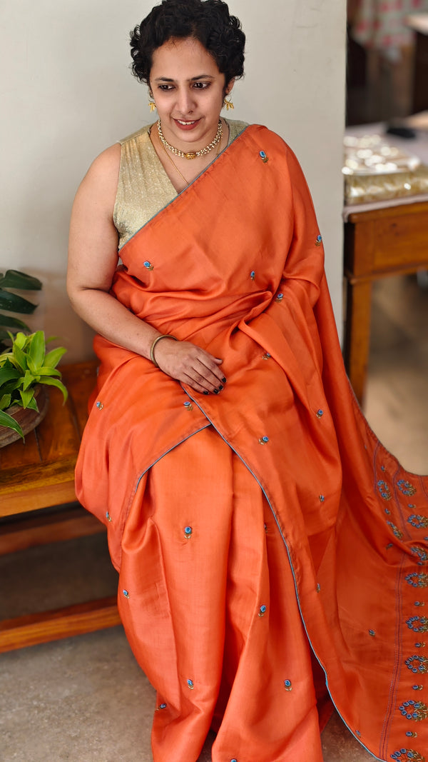 Orange muslin silk saree with hand embroidery